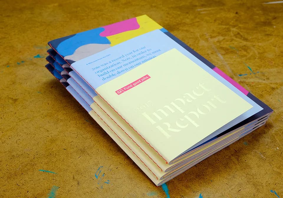 2017 Impact Report physical object with layered cover and paper edges.